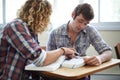 Students, reading and textbook with teamwork in university class for academic research, higher education or assignment Royalty Free Stock Photo