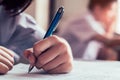 Students reading and writing answer doing exam in classroom with stress Royalty Free Stock Photo