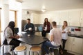 Students Relaxing In Kitchen Of Shared Accommodation