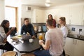 Students Relaxing In Kitchen Of Shared Accommodation Royalty Free Stock Photo