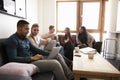 Students Relaxing In Lounge Of Shared Accommodation Royalty Free Stock Photo