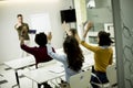 Students rising hands to answer the question during the workshop training Royalty Free Stock Photo