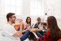 Students sharing pizza at home party Royalty Free Stock Photo