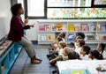 Students sitting on the floor listening to teacher