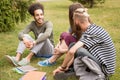 Students sitting at lawn talking after classes. Royalty Free Stock Photo