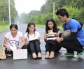 Students sitting on the road and sharing notes. Royalty Free Stock Photo