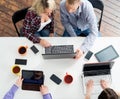 Students sitting at the table using computers and tablets Royalty Free Stock Photo