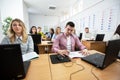 Students sitting at their desks listening close Royalty Free Stock Photo