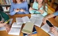 Students with smartphones making cheat sheets Royalty Free Stock Photo