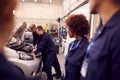 Students Studying For Auto Mechanic Apprenticeship At College Working On Car Engine Royalty Free Stock Photo