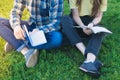 Students studying outdoors sitting on the grass