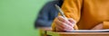 Students taking exam in classroom. Education test and literacy concept. Cropped shot, hand detail. Royalty Free Stock Photo