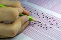 Students taking exams, writing examination room with holding pencil on optical form of standardized test with answers paper Royalty Free Stock Photo