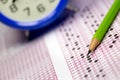 Students taking exams, writing examination room with holding pencil on optical form of standardized test with answers paper Royalty Free Stock Photo