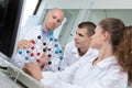 Students and teacher looking at model representing dna molecules Royalty Free Stock Photo