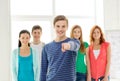 Students with teenager in front pointing at you Royalty Free Stock Photo