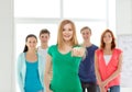 Students with teenager in front pointing at you Royalty Free Stock Photo