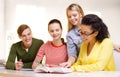 Students with textbooks and books at school Royalty Free Stock Photo