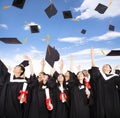 students throwing graduation caps into the Air Royalty Free Stock Photo