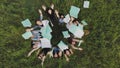 Students toss exercise books on their last day of school.