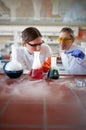 Students in uniform making some experiment in lab Royalty Free Stock Photo