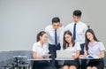 Students in uniform working with laptop