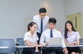 Students in uniform working with laptop