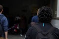 Students at the university campus. People in the corridors of the educational building. A student with a backpack from the back