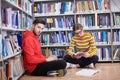 the students uses a notebook, laptop and a school library Royalty Free Stock Photo