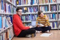 the students uses a notebook, laptop and a school library Royalty Free Stock Photo