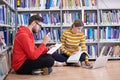 the students uses a notebook, laptop and a school library Royalty Free Stock Photo