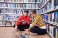 the students uses a notebook, laptop and a school library Royalty Free Stock Photo
