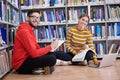 the students uses a notebook, laptop and a school library Royalty Free Stock Photo