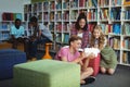 Students using digital tablet in library Royalty Free Stock Photo