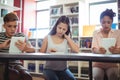 Students using digital tablet in library Royalty Free Stock Photo