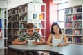 Students using digital tablet in library Royalty Free Stock Photo