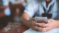 Students using smartphone and doing exam answer sheets exercises in classroom of school.16:9 style Royalty Free Stock Photo