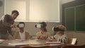 Students using vr glasses. teacher helping pupils to learn science with gadgets Royalty Free Stock Photo