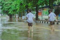 Students walk to the flood after rain