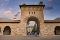 Students walking through archway at Stanford University campus