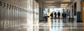 Students walking through a bright school hallway with lockers during midday Royalty Free Stock Photo