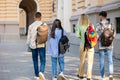 Students walking in college campus after classes carrying backpacks going to lessons. Royalty Free Stock Photo