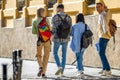Students walking in college campus after classes carrying backpacks going to lessons. Royalty Free Stock Photo
