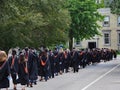 Students walking outdoors to graduation ceremony Royalty Free Stock Photo