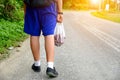 Students walking to home,Hand carrying bags for fruit and food. Royalty Free Stock Photo