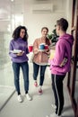 Students wearing casual clothes having coffee break between classes Royalty Free Stock Photo