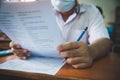 Students wearing face mask for protect corona virus or covid-19 and doing exam in classroom with stress Royalty Free Stock Photo