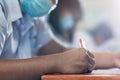 Students wearing mask for protect corona virus or covid-19 and doing exam in classroom with stress Royalty Free Stock Photo
