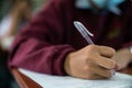 Students wearing mask for protect corona virus or covid-19 and doing exam in classroom with stress Royalty Free Stock Photo