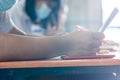 Students wearing mask for protect corona virus or covid-19 and doing exam in classroom with stress Royalty Free Stock Photo